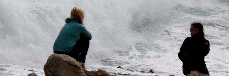 High waves at Stanfordsbaai yesterday. Visitors watching the whales while sitting at the far end of the rocks right in the way of the waves.